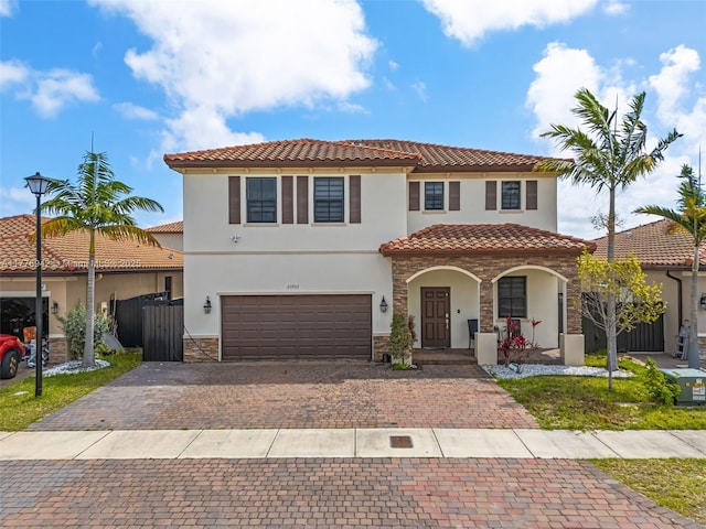 23703 SW 116th Ct, Homestead, FL 33032 - mediterranean / spanish home featuring a tile roof, stucco siding, stone siding, driveway, and a porch