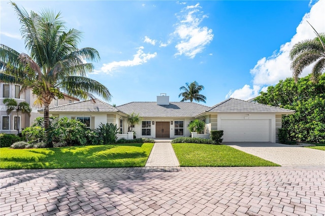 872 NE 79, Boca Raton, FL 33487 - ranch-style house featuring stucco siding, a garage, decorative driveway, a front lawn, and a chimney