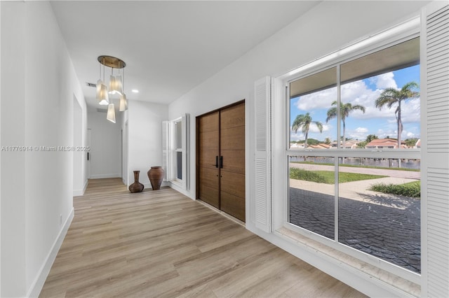 872 NE 79, Boca Raton, FL 33487 - hallway with light wood-style flooring, baseboards, a water view, and recessed lighting