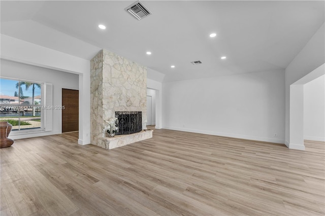 872 NE 79, Boca Raton, FL 33487 - unfurnished living room with light wood finished floors, a stone fireplace, vaulted ceiling, baseboards, and recessed lighting