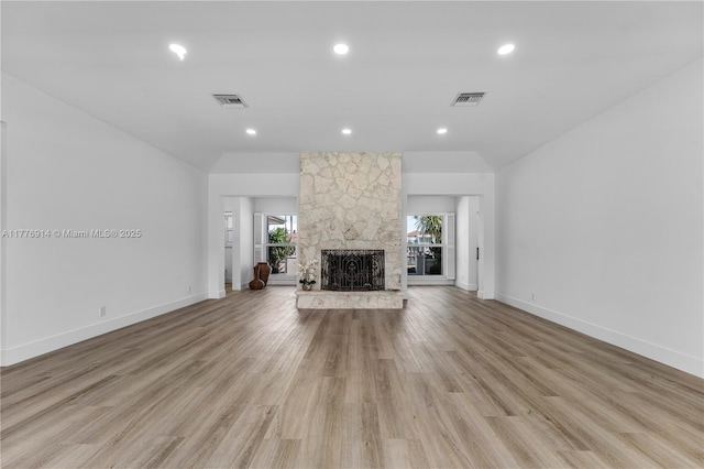 872 NE 79, Boca Raton, FL 33487 - unfurnished living room featuring a fireplace, vaulted ceiling, light wood-style floors, recessed lighting, and baseboards