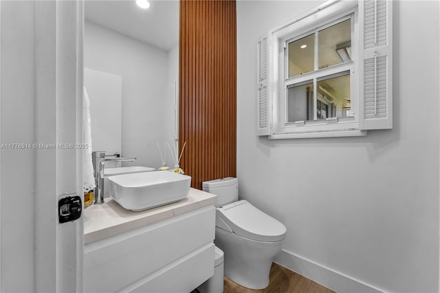 872 NE 79, Boca Raton, FL 33487 - bathroom featuring baseboards, wood finished floors, toilet, recessed lighting, and vanity