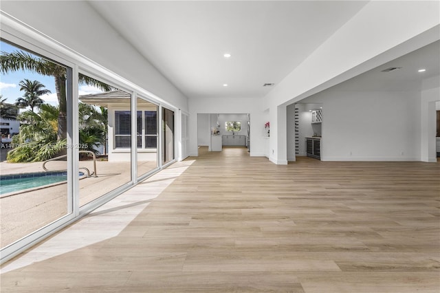 872 NE 79, Boca Raton, FL 33487 - unfurnished living room with recessed lighting, baseboards, and light wood-type flooring
