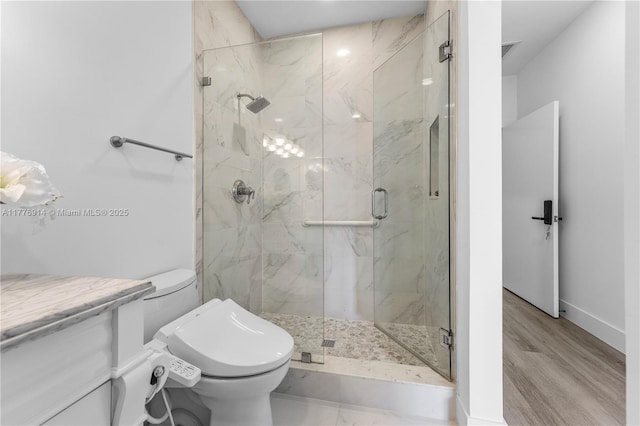 872 NE 79, Boca Raton, FL 33487 - bathroom featuring toilet, a marble finish shower, baseboards, and wood finished floors