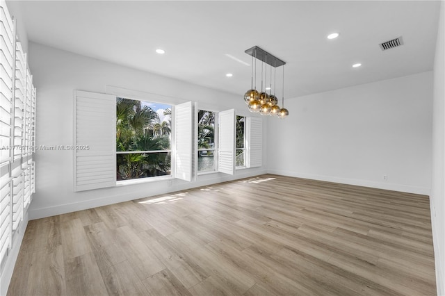 872 NE 79, Boca Raton, FL 33487 - spare room with recessed lighting, light wood finished floors, baseboards, and a chandelier