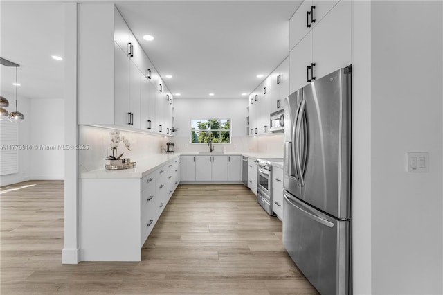 872 NE 79, Boca Raton, FL 33487 - kitchen with stainless steel appliances, light countertops, light wood-type flooring, tasteful backsplash, and recessed lighting