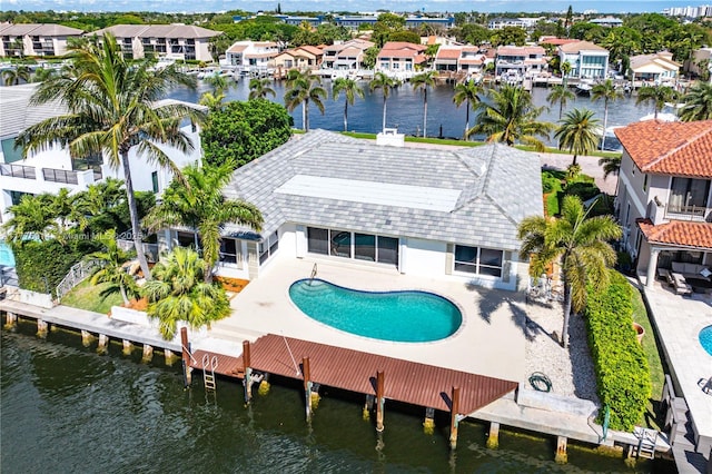 872 NE 79, Boca Raton, FL 33487 - rear view of property featuring a residential view, a water view, an outdoor pool, and stucco siding