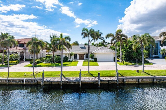 872 NE 79, Boca Raton, FL 33487 - back of house with a water view, driveway, a garage, and a yard