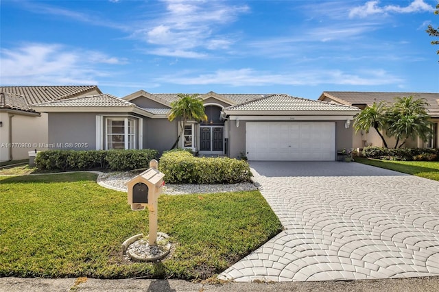 3881 Hidden Cypress Way, Lake Worth, FL 33467 - ranch-style house with a garage, stucco siding, a front lawn, decorative driveway, and a tiled roof
