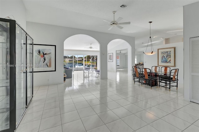 3881 Hidden Cypress Way, Lake Worth, FL 33467 - tiled dining space with ceiling fan, arched walkways, and vaulted ceiling