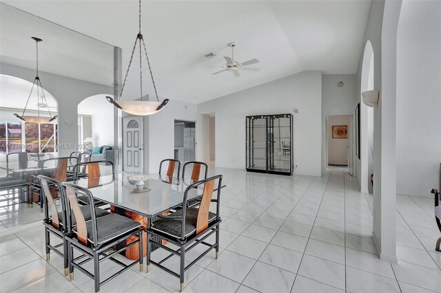 3881 Hidden Cypress Way, Lake Worth, FL 33467 - dining room with arched walkways, a ceiling fan, vaulted ceiling, and light tile patterned floors