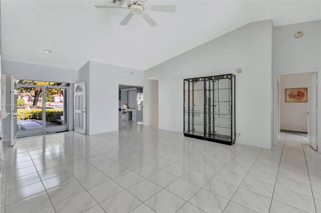 3881 Hidden Cypress Way, Lake Worth, FL 33467 - empty room featuring light tile patterned floors, ceiling fan, and high vaulted ceiling