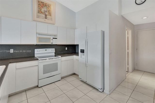 3881 Hidden Cypress Way, Lake Worth, FL 33467 - kitchen featuring white appliances, dark countertops, high vaulted ceiling, white cabinets, and backsplash