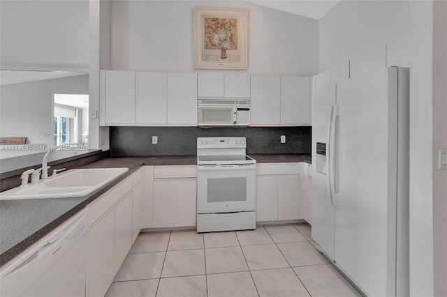 3881 Hidden Cypress Way, Lake Worth, FL 33467 - kitchen featuring white appliances, dark countertops, backsplash, and white cabinetry