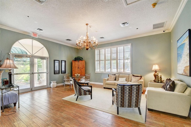 3881 Hidden Cypress Way, Lake Worth, FL 33467 - living area with crown molding, wood finished floors, a textured ceiling, and a chandelier