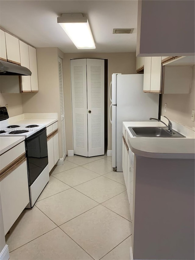 kitchen with light countertops, white range with electric stovetop, light tile patterned floors, under cabinet range hood, and a sink