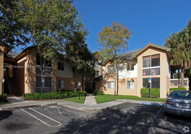 view of property featuring uncovered parking