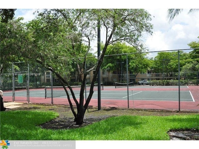 view of sport court featuring fence