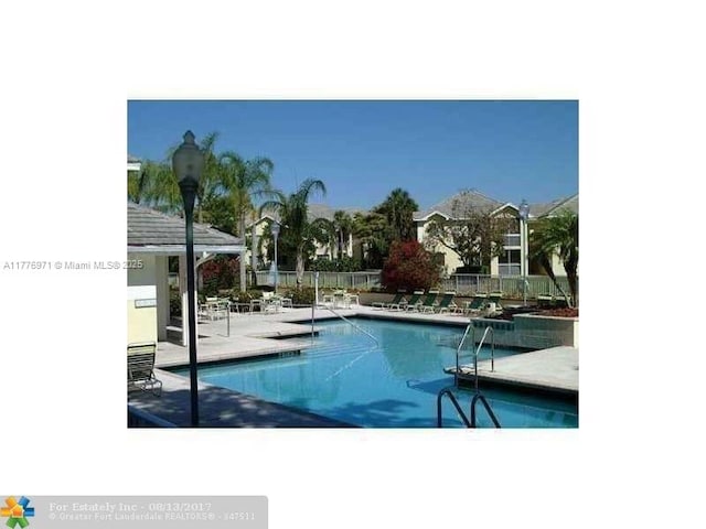 community pool featuring a patio and fence