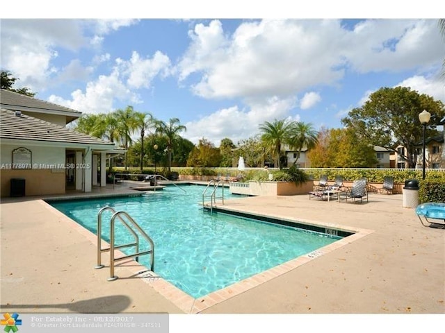 community pool featuring a patio area