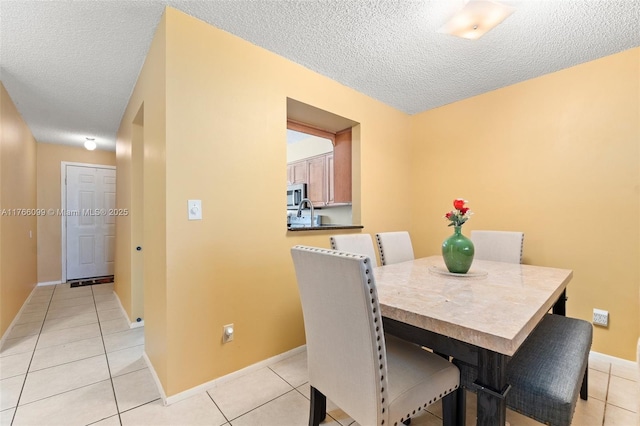6034 Indrio Rd Unit 7, Fort Pierce, FL 34951 - dining room with a textured ceiling, light tile patterned floors, and baseboards