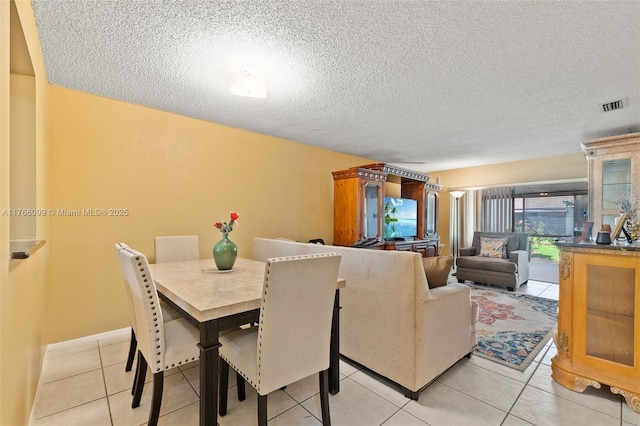 6034 Indrio Rd Unit 7, Fort Pierce, FL 34951 - dining space with visible vents, light tile patterned floors, and a textured ceiling