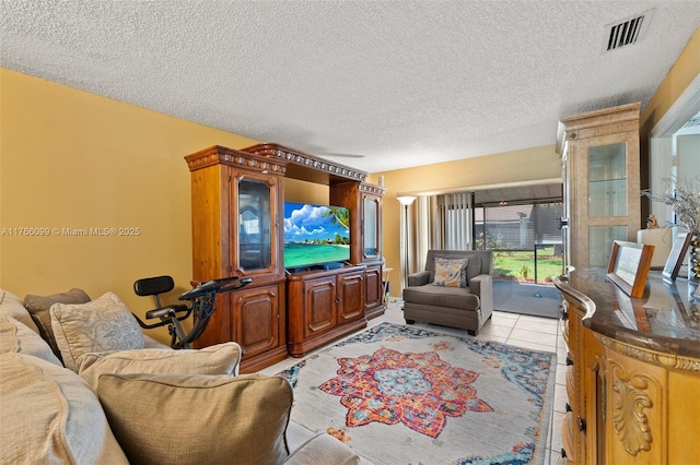 6034 Indrio Rd Unit 7, Fort Pierce, FL 34951 - living room with light tile patterned floors, visible vents, and a textured ceiling