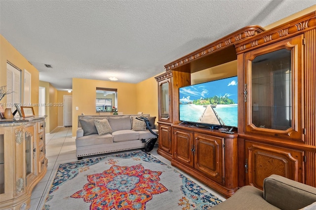 6034 Indrio Rd Unit 7, Fort Pierce, FL 34951 - living room featuring a textured ceiling, light tile patterned flooring, and visible vents