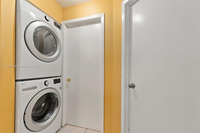 6034 Indrio Rd Unit 7, Fort Pierce, FL 34951 - clothes washing area featuring laundry area, light tile patterned floors, a textured ceiling, and stacked washer / drying machine