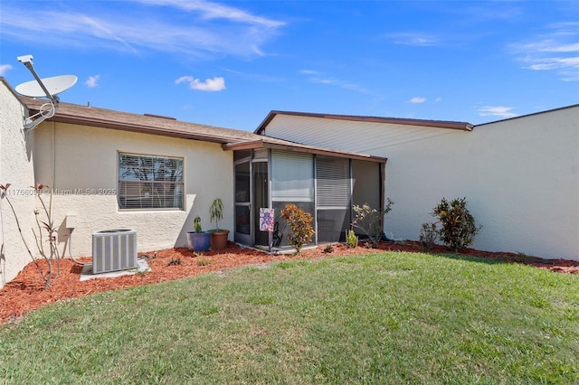 6034 Indrio Rd Unit 7, Fort Pierce, FL 34951 - exterior space with stucco siding, cooling unit, a sunroom, and a lawn