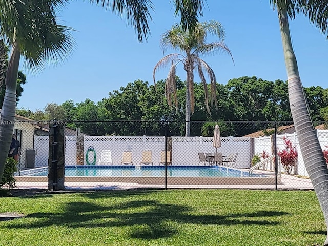 6034 Indrio Rd Unit 7, Fort Pierce, FL 34951 - view of pool with a fenced in pool, fence, and a lawn