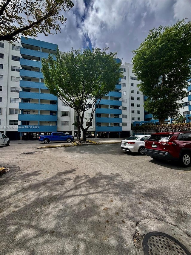 view of building exterior featuring uncovered parking