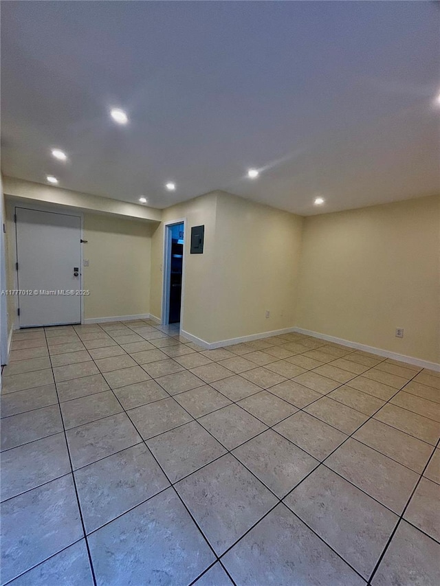 unfurnished room featuring baseboards, recessed lighting, and light tile patterned floors