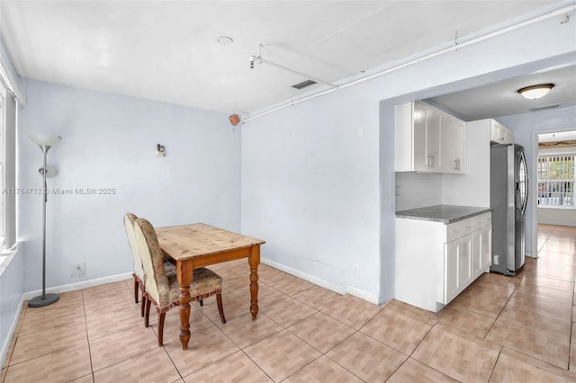 1910 NE 56th St, Fort Lauderdale, FL 33308 - dining space featuring light tile patterned flooring and baseboards