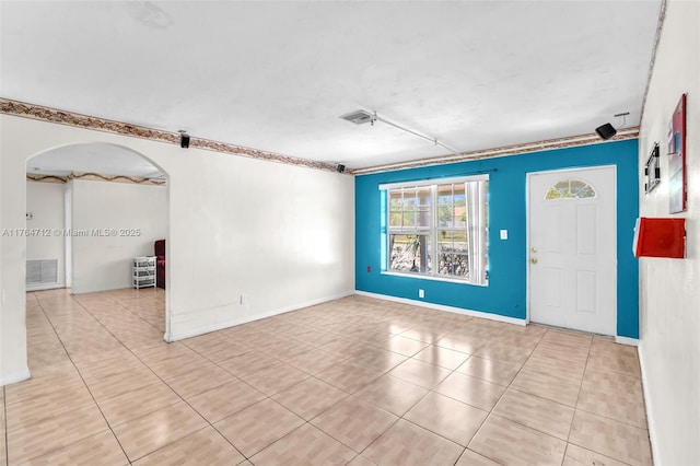 1910 NE 56th St, Fort Lauderdale, FL 33308 - tiled empty room with arched walkways and baseboards