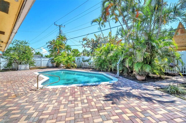 1910 NE 56th St, Fort Lauderdale, FL 33308 - view of swimming pool with a fenced backyard and a patio