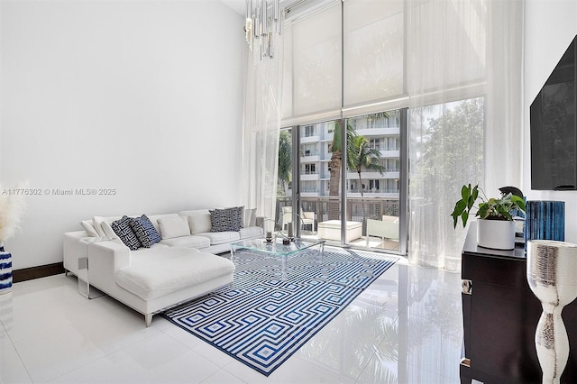 living area featuring tile patterned flooring and a towering ceiling