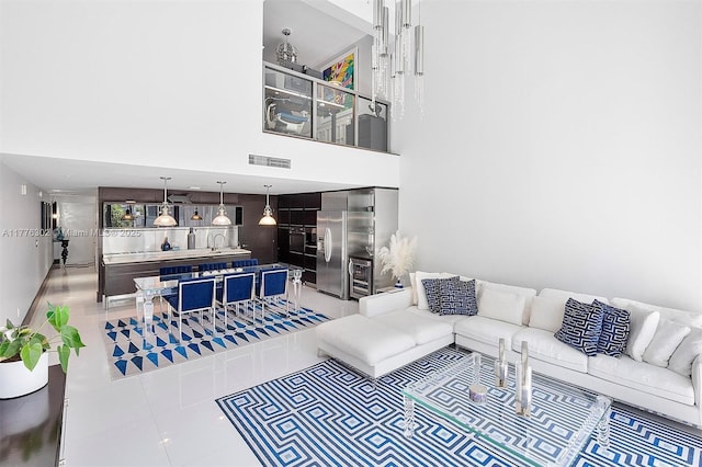 living room with visible vents and a high ceiling