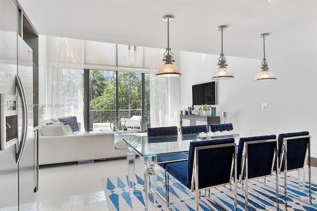kitchen with tile patterned flooring, pendant lighting, and stainless steel fridge with ice dispenser