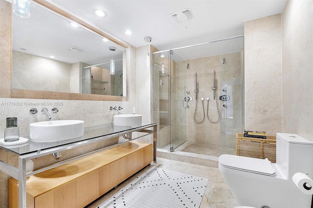 full bath featuring a sink, tile walls, decorative backsplash, and a stall shower