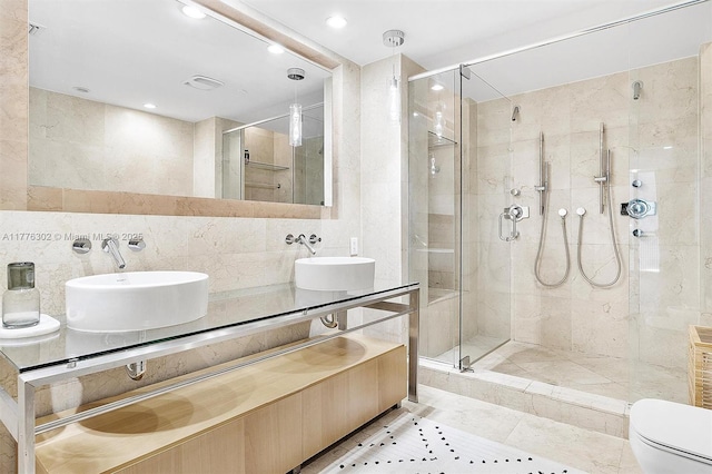 bathroom with a shower stall and a sink