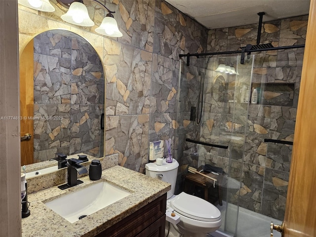 full bath featuring a shower stall, toilet, and vanity
