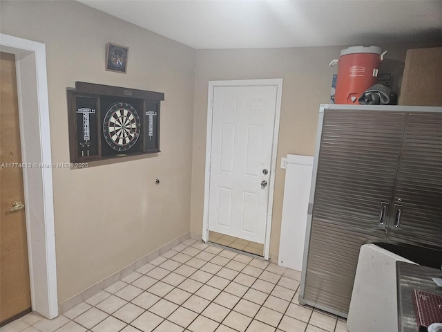 interior space with baseboards and light tile patterned floors