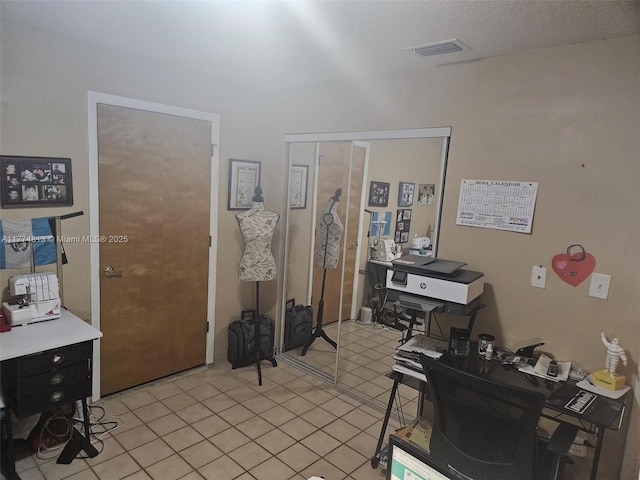 office space with light tile patterned floors and visible vents