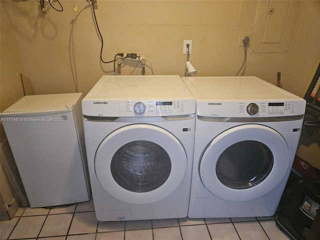 laundry area featuring light tile patterned flooring, laundry area, and washer and dryer