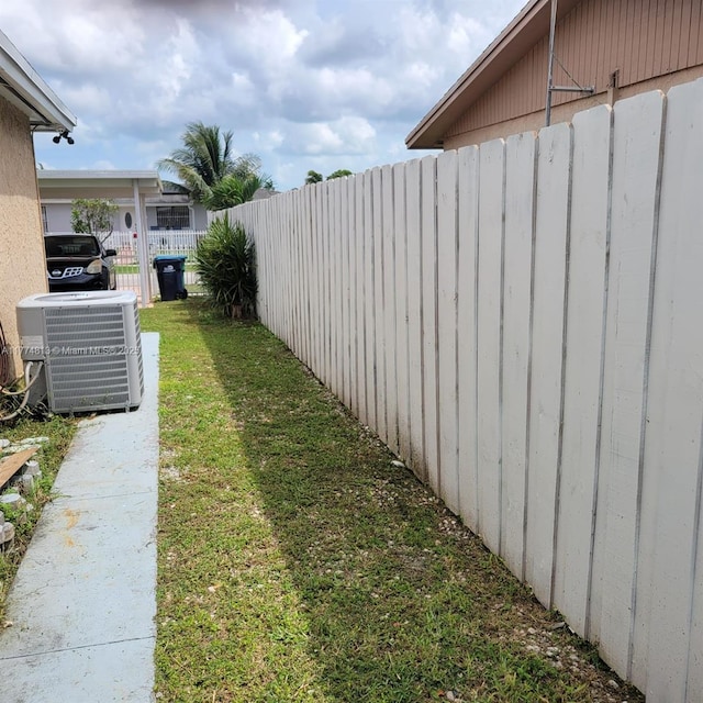 view of yard featuring fence and cooling unit