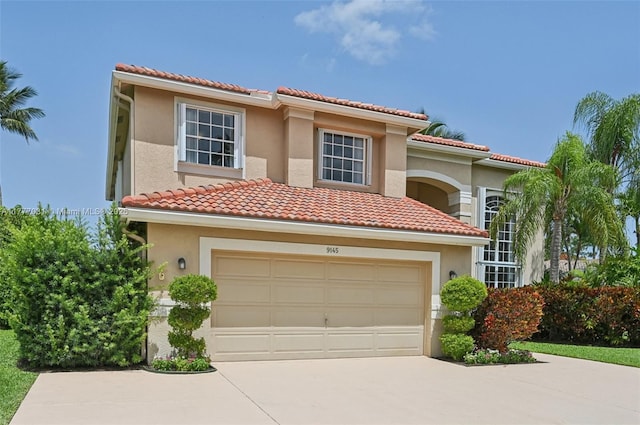9145 Picot Ct, Boynton Beach, FL 33472 - mediterranean / spanish house with driveway, an attached garage, stucco siding, and a tile roof
