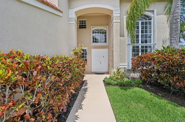 9145 Picot Ct, Boynton Beach, FL 33472 - view of exterior entry featuring stucco siding