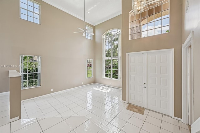 9145 Picot Ct, Boynton Beach, FL 33472 - foyer entrance with a high ceiling, healthy amount of natural light, baseboards, ornamental molding, and light tile patterned flooring