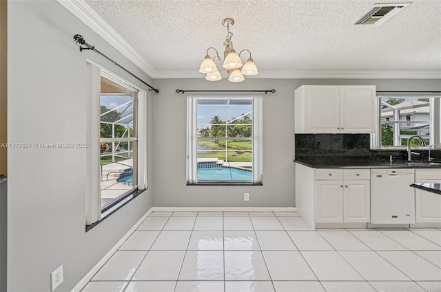 9145 Picot Ct, Boynton Beach, FL 33472 - kitchen featuring dishwasher, a textured ceiling, a chandelier, plenty of natural light, and crown molding